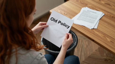 woman tossing old insurance policy in trash generated with Z-Image